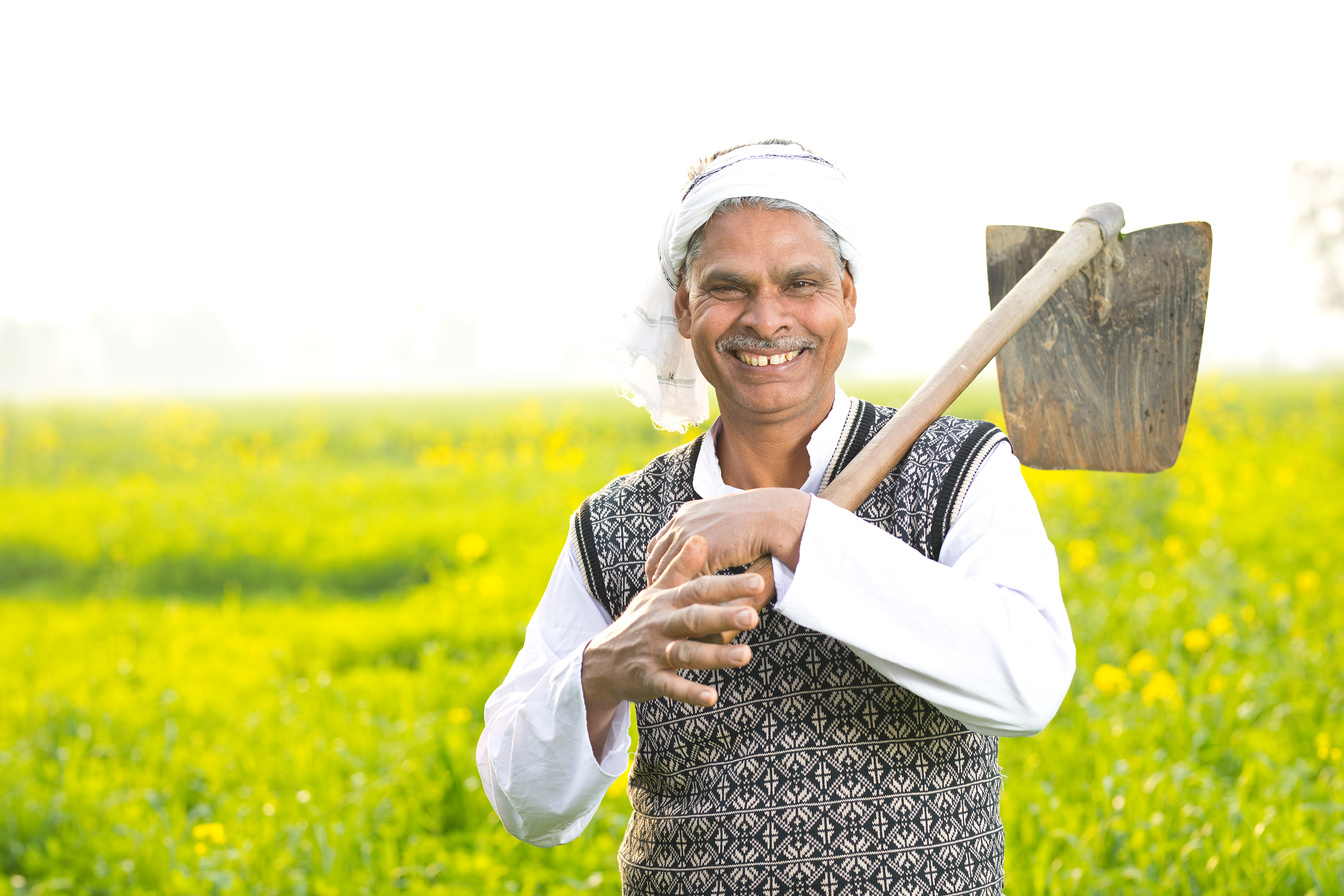 Indian farmer holding hoe